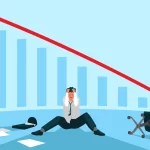 Homem sentado no chão com as mãos na cabeça com um gráfico de queda acentuada ao fundo