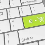 Tecla verde de teclado com ícone de carrinho de compras representando e-commerce