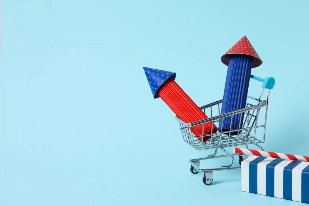 Carrinho de compras com foguetes decorativos azuis e vermelhos sobre fundo azul claro, simbolizando o crescimento acelerado das tendências de vendas no Mercado Livre