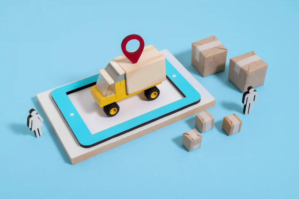 Ilustração de caminhão sobre um tablet com marcador de localização vermelho, cercado por miniaturas de caixas e figuras humanas, simbolizando logística digital e otimizar frete no Mercado Livre