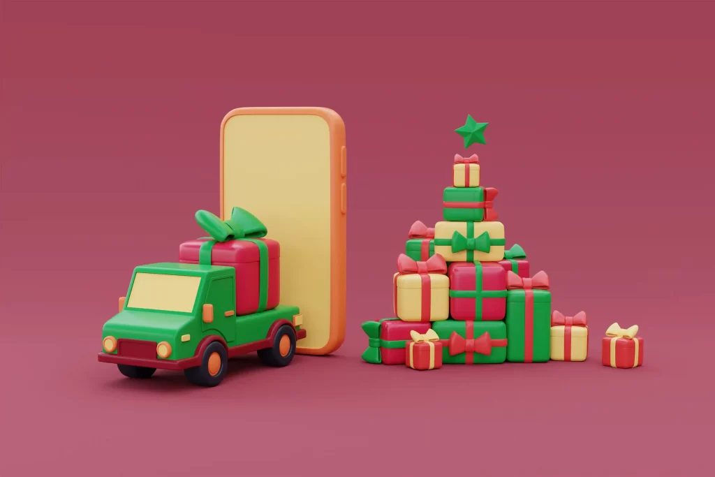 Caminhão de entrega com presente e pilha de caixas coloridas ao lado de um smartphone, representando compras online no Natal 2025