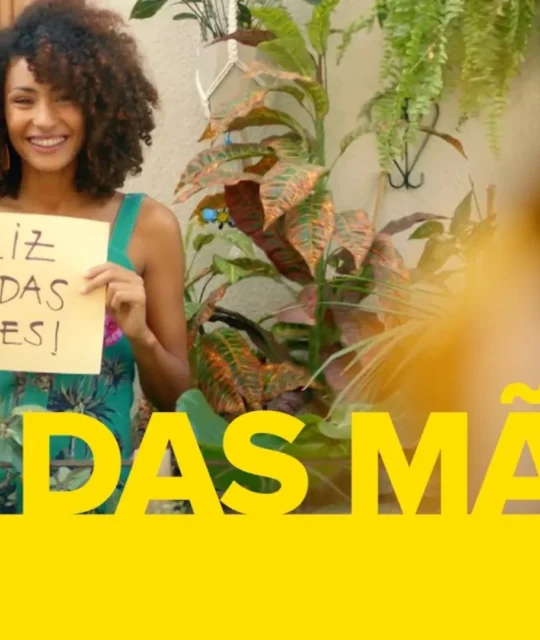 Mulher sorrindo segurando cartaz escrito Feliz Dia das Mães em campanha do Mercado Livre, ilustrando como vender no Dia das Mães pelo Mercado Livre