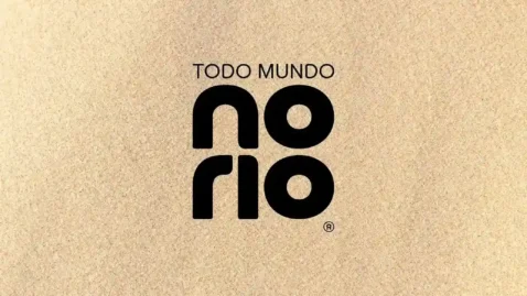 Logo oficial do evento Todo Mundo no Rio em fundo texturizado bege, marca registrada do festival que recebe o show da Shakira no Rio de Janeiro em 2026