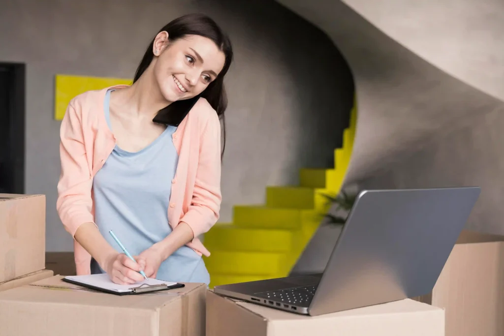 Empreendedora anotando em prancheta ao lado de caixas e notebook, ilustrando como negociar com fornecedor no e-commerce e melhorar a margem sem aumentar volume