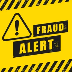 Placa amarela de alerta de fraude com símbolo de atenção e a mensagem “Fraud Alert”